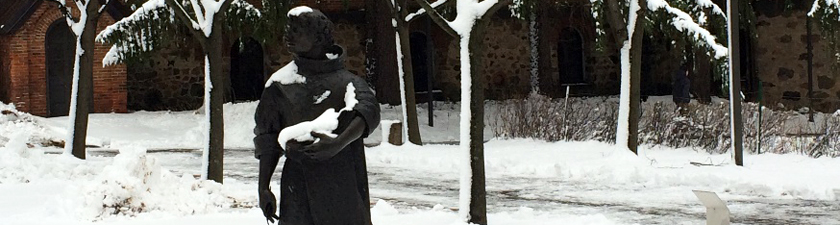 Statue of St. Benedict at Saint John’s University, covered in a dusting of new snow
