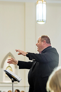 Bill Frederick conducts a choir
