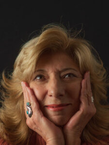 Jean Feraca holds her face in her hands