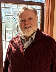 Bill Santner II stands in front of a window
