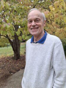 Max Harris stands in a park